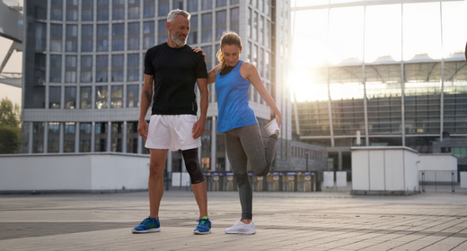 Couple stretching before a run while wearing Copper Fit products. product
