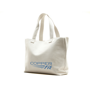 Person holding a tote bag with 'Copper Fit' logo