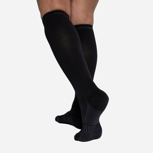 Graduated compression socks infused with shea butter, coconut oil, Vitamin E, and aloe vera for hydration