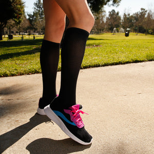 Graduated compression socks infused with shea butter, coconut oil, Vitamin E, and aloe vera for hydration