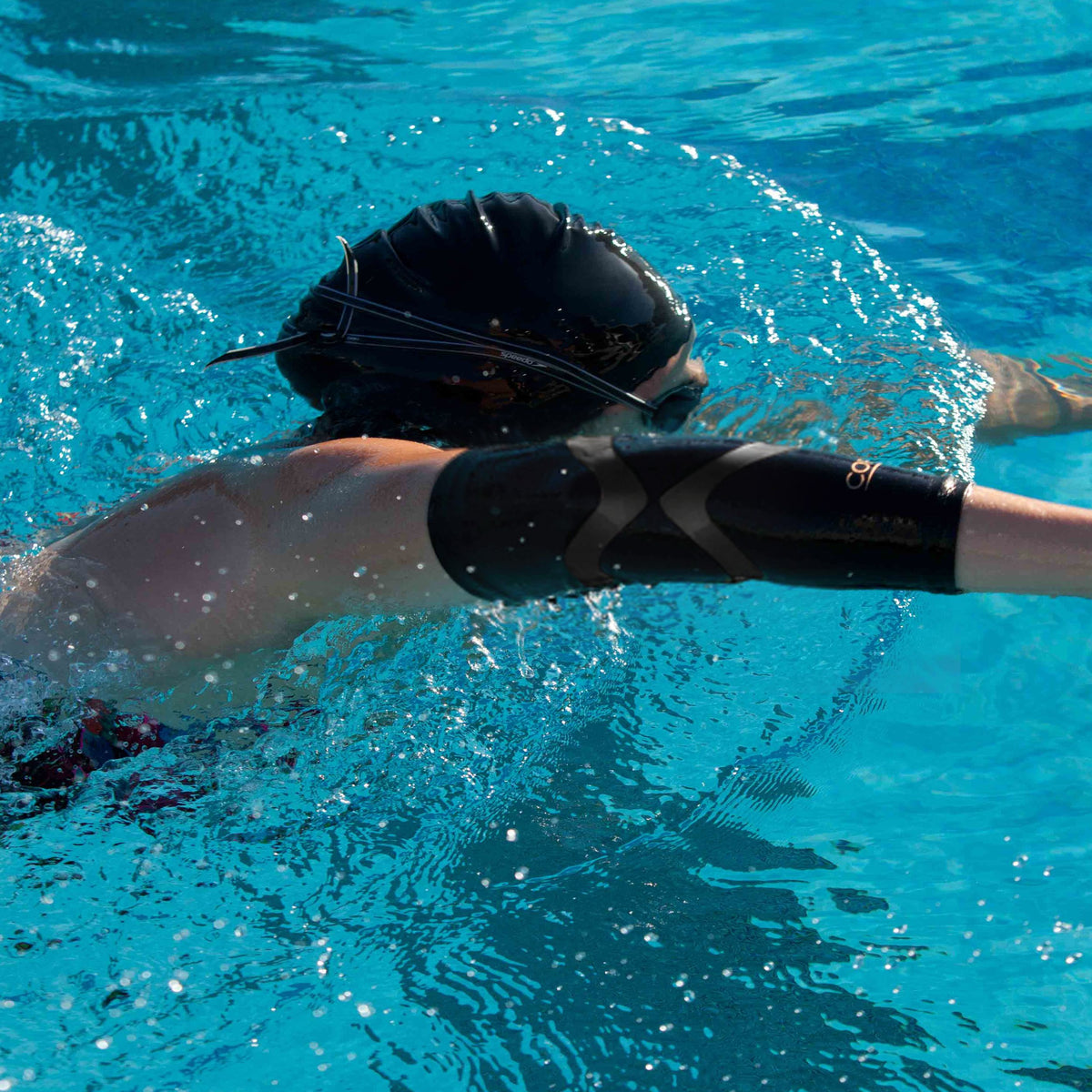 Compression sleeve around elbow with built in kinesiology tape for support and all-day comfort.
