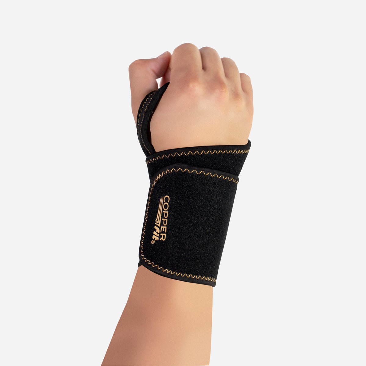 Person wearing Copper Fit wrist support with thumb loop, providing comfort and support for joint stability and relief.