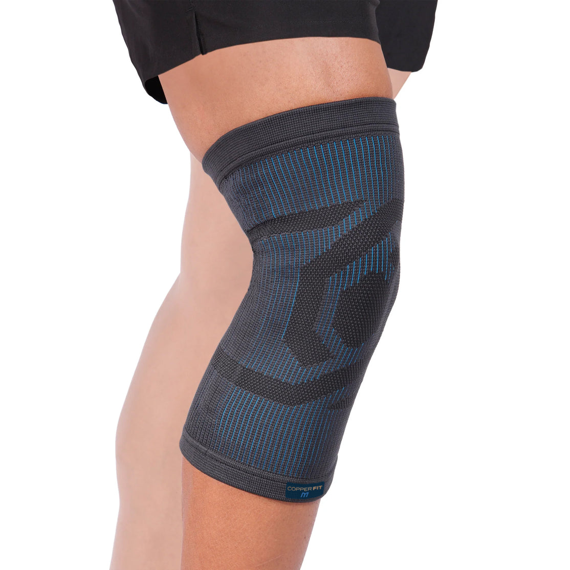 A compression knee sleeve with a geometric pattern, primarily black with blue accents.