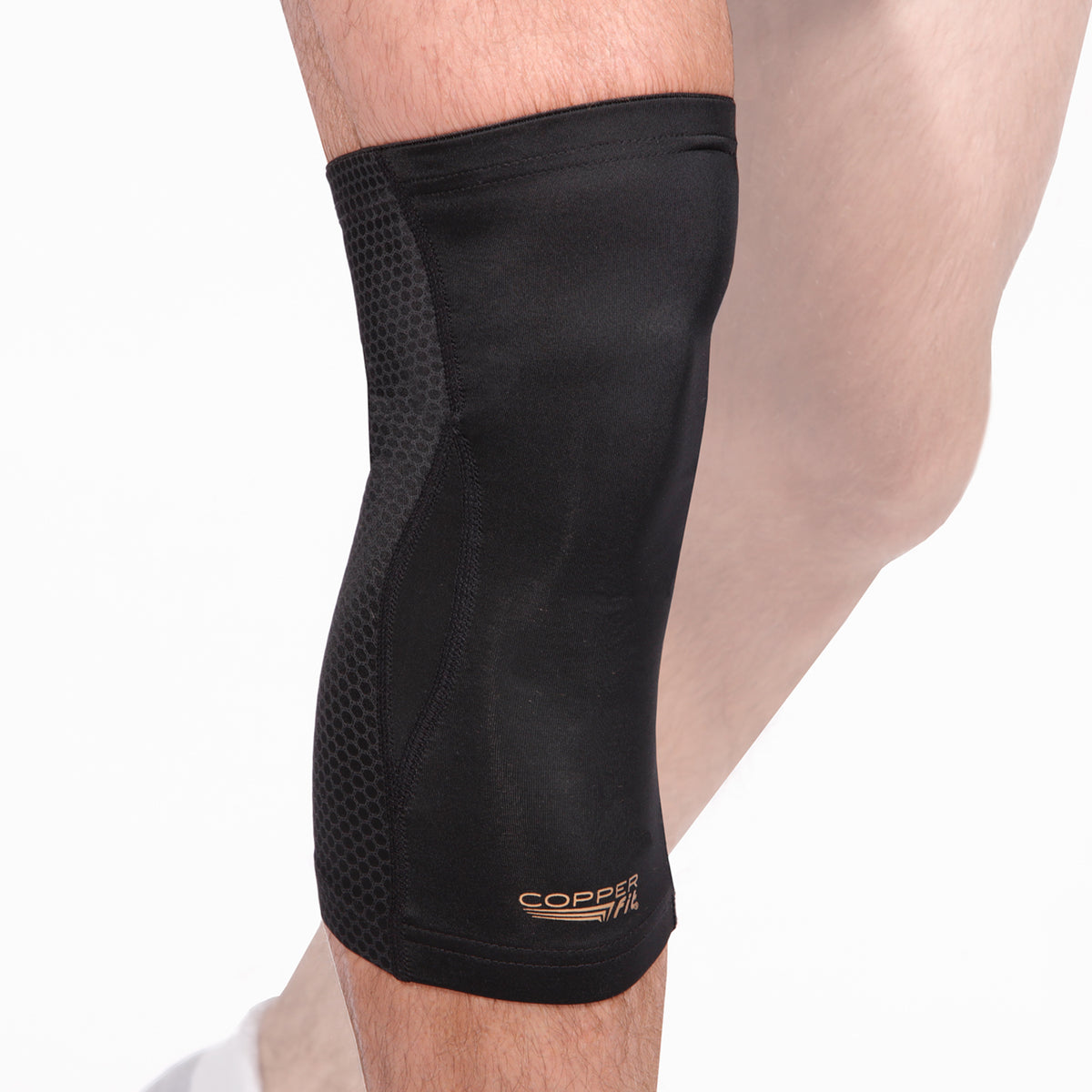 Black knee brace with mesh design on a person&#39;s leg against a white background